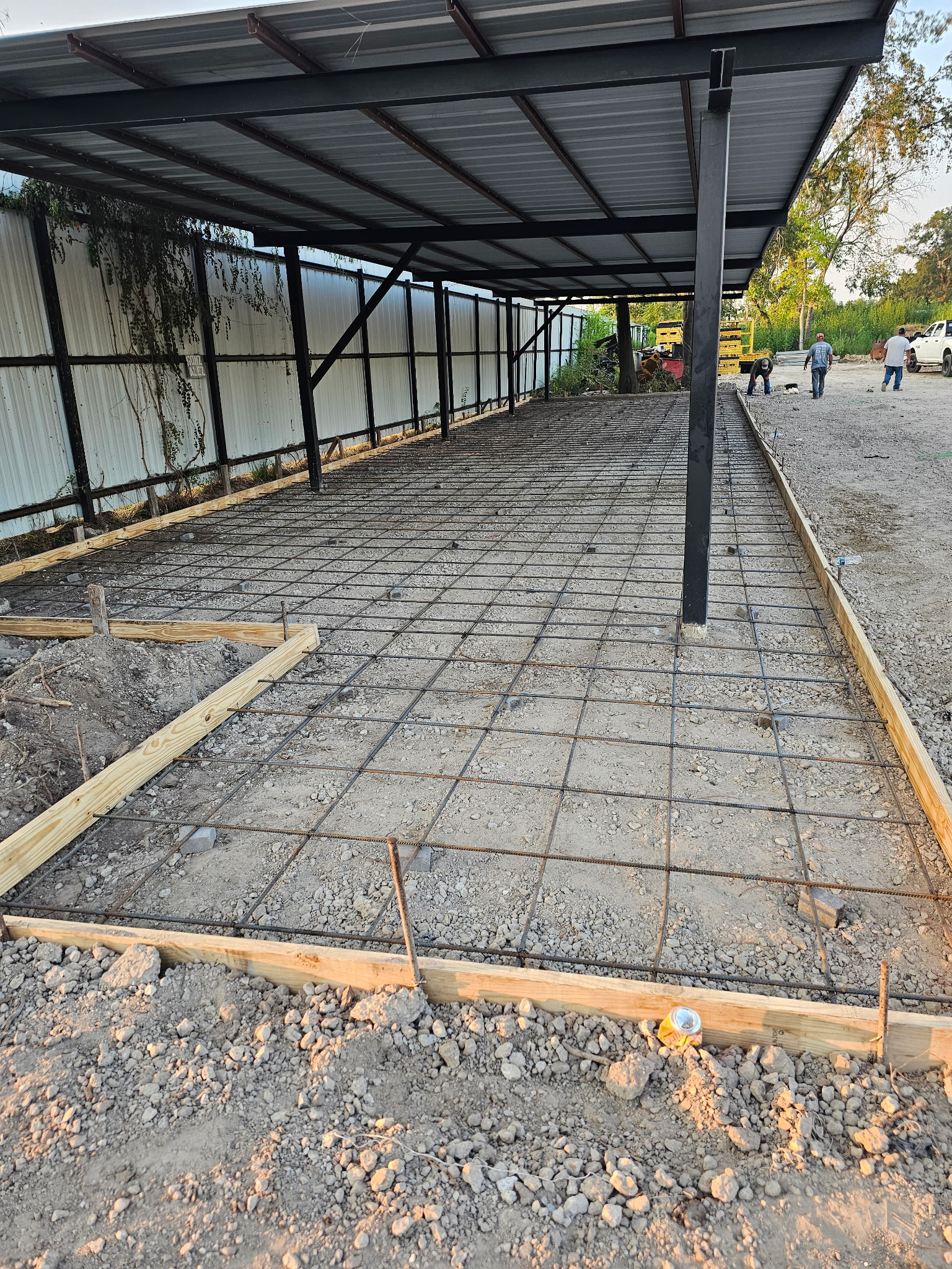 Formwork and reinforcement under a metal canopy before concrete placement